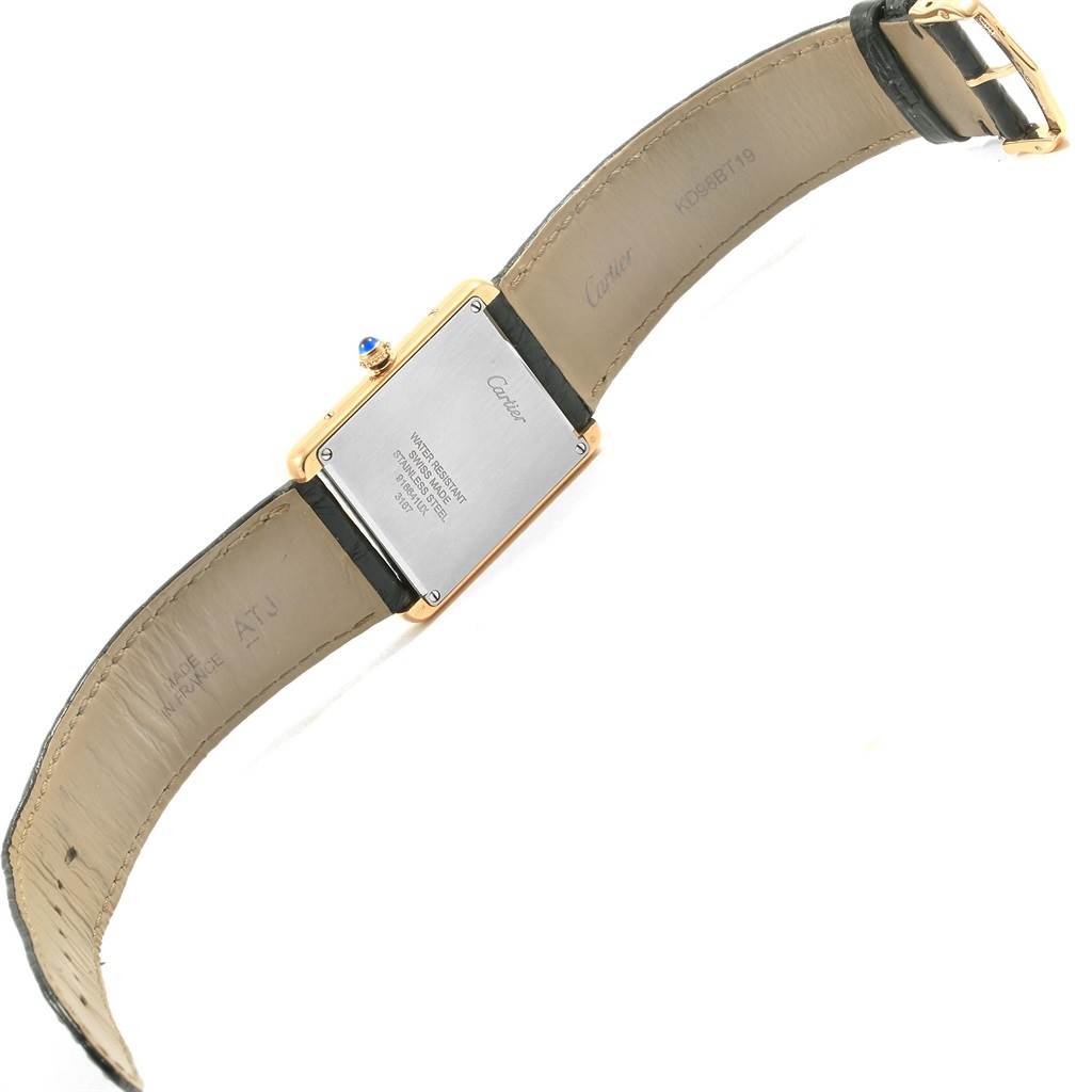 The image shows the back view of a Cartier Tank Solo W1018855 Men
s Steel and Gold (two tone) Silver Dial W1018855 Men
s Steel and Gold (two tone) Silver Dial watch, highlighting its leather strap and stainless steel case back.