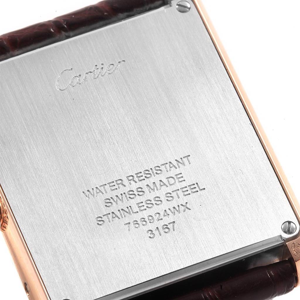 The image shows the back case of a Cartier Tank Solo W5200025 Men
s Steel and Gold (two tone) Silver Dial W5200025 Men
s Steel and Gold (two tone) Silver Dial watch, highlighting the inscriptions and leather strap edges.