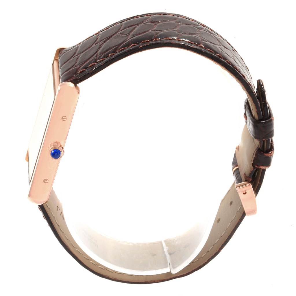 The Cartier Tank Solo W5200025 Men
s Steel and Gold (two tone) Silver Dial W5200025 Men
s Steel and Gold (two tone) Silver Dial watch is shown from a side angle, displaying the brown leather strap and crown with a blue gemstone.