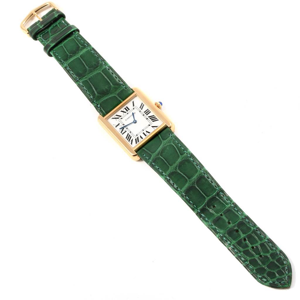 The image shows a Cartier Tank Solo W1018855 Steel and Gold (two tone) Silver Dial W1018855 Steel and Gold (two tone) Silver Dial watch with a rectangular gold case and green leather strap, viewed from the top.