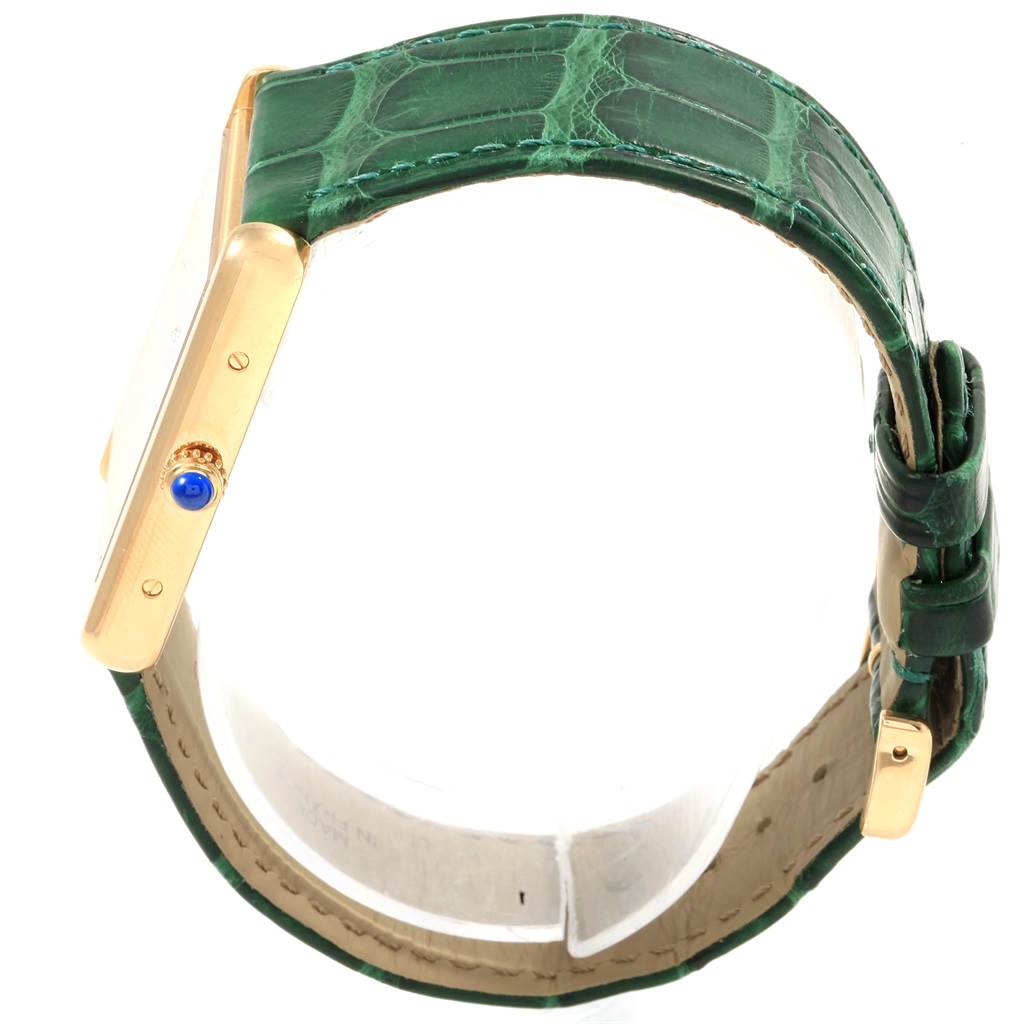 The image shows a side view of a Cartier Tank Solo W1018855 Steel and Gold (two tone) Silver Dial W1018855 Steel and Gold (two tone) Silver Dial watch, highlighting its green leather strap and gold casing with a sapphire crown.