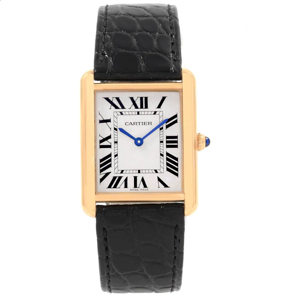 The image shows a Cartier Tank Solo W1018855 Men's Steel and Gold (two tone) Silver Dial W1018855 Men's Steel and Gold (two tone) Silver Dial watch with a rectangular gold case, white dial, Roman numerals, blue hands, and a black leather strap.