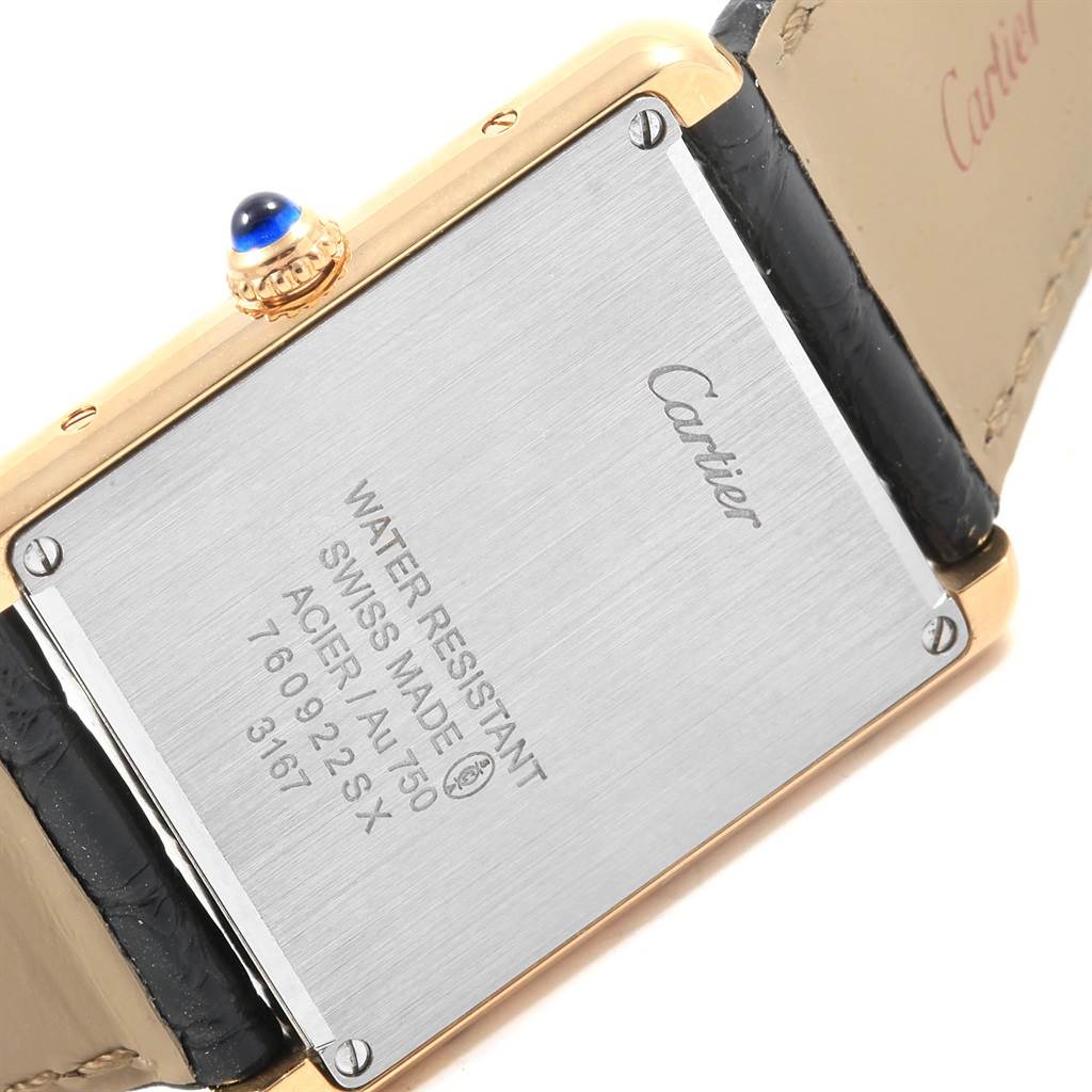 This image shows the back case and part of the strap of a Cartier Tank Solo W1018855 Men's Steel and Gold (two tone) Silver Dial W1018855 Men's Steel and Gold (two tone) Silver Dial watch.