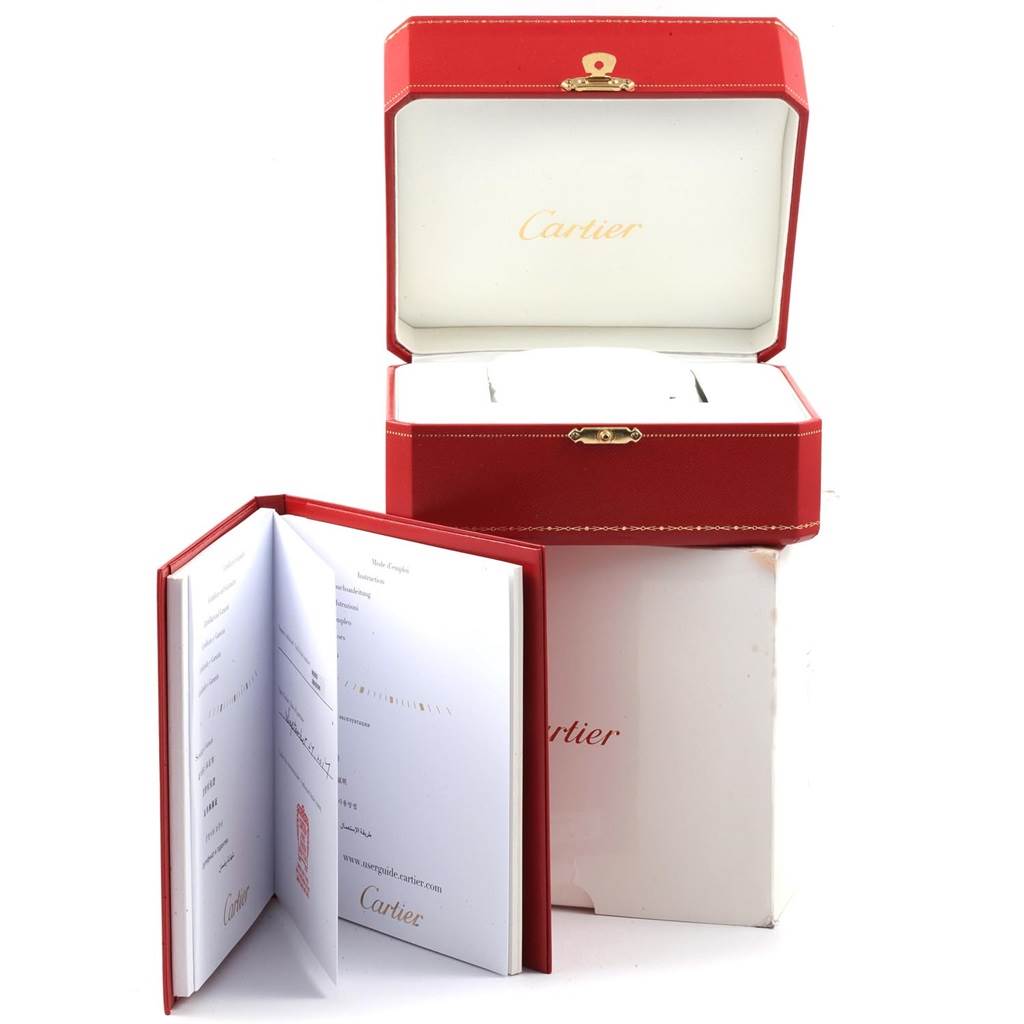 The image shows the packaging and user manual for the Cartier Tank Solo W5200028 Men
s Stainless Steel Silver Dial W5200028 Men
s Stainless Steel Silver Dial watch, with an open red box and booklet.