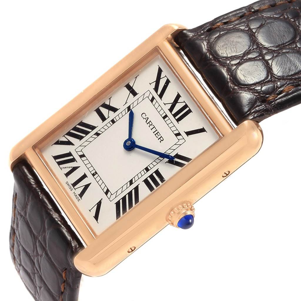 The Cartier Tank Solo W5200025 Women's Steel and Gold (two tone) Silver Dial W5200025 Women's Steel and Gold (two tone) Silver Dial watch is shown from a tilted angle, displaying its rectangular face, Roman numerals, blue hands, and leather strap.
