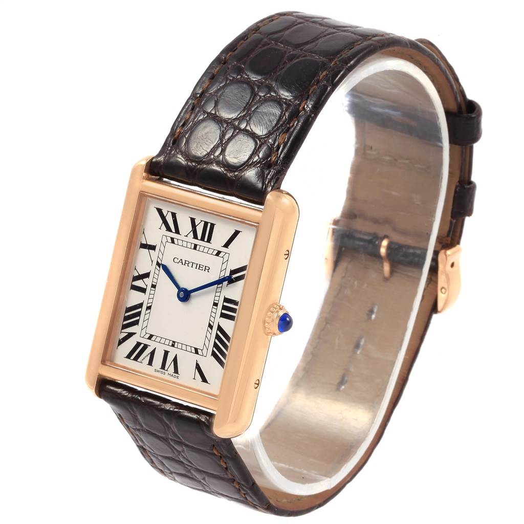 The Cartier Tank Solo W5200025 Women's Steel and Gold (two tone) Silver Dial W5200025 Women's Steel and Gold (two tone) Silver Dial watch is shown at an angle displaying its face, leather strap, and gold case with a blue cabochon crown.