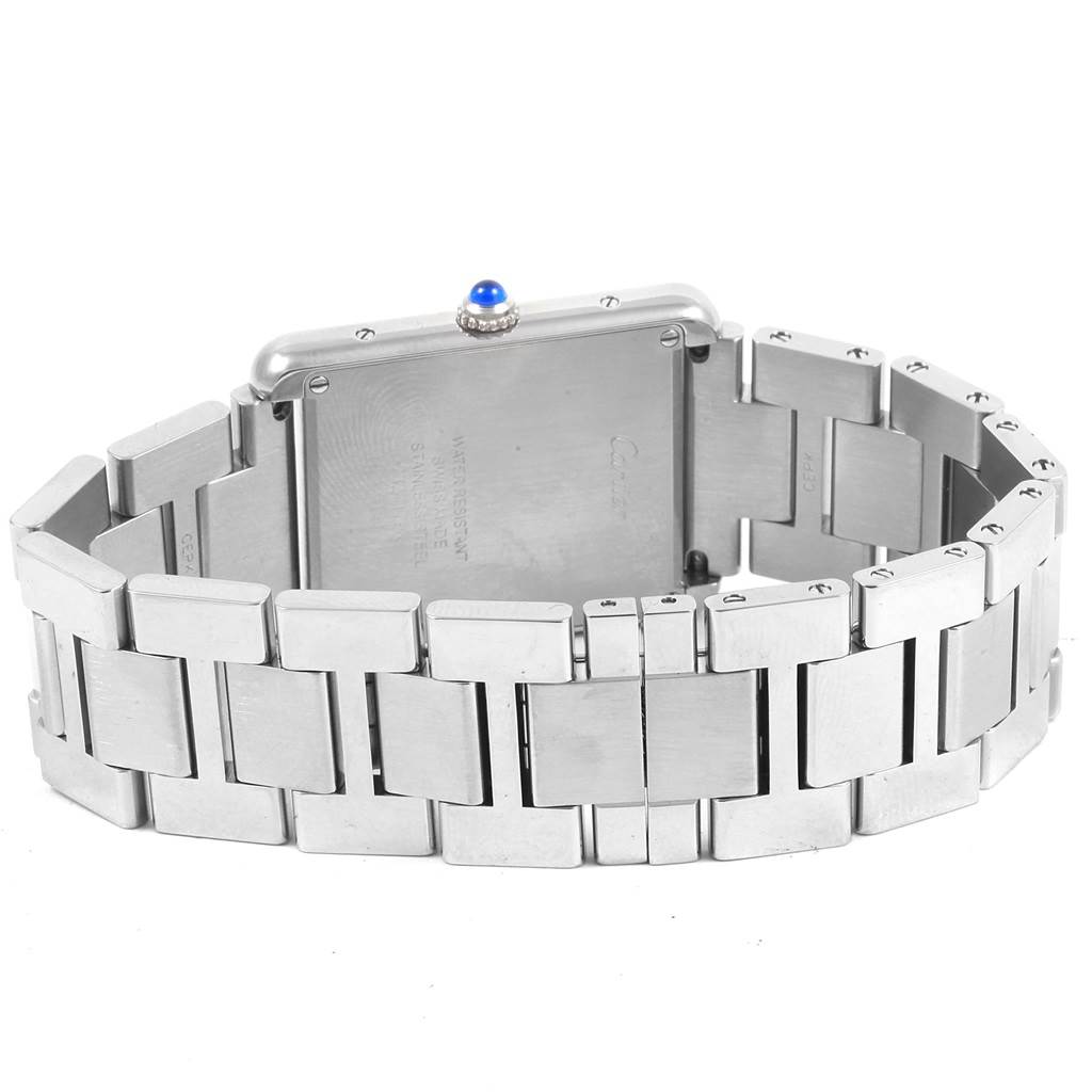 The image shows the back and side view of a Tank Solo Cartier watch, focusing on the stainless steel bracelet and caseback.