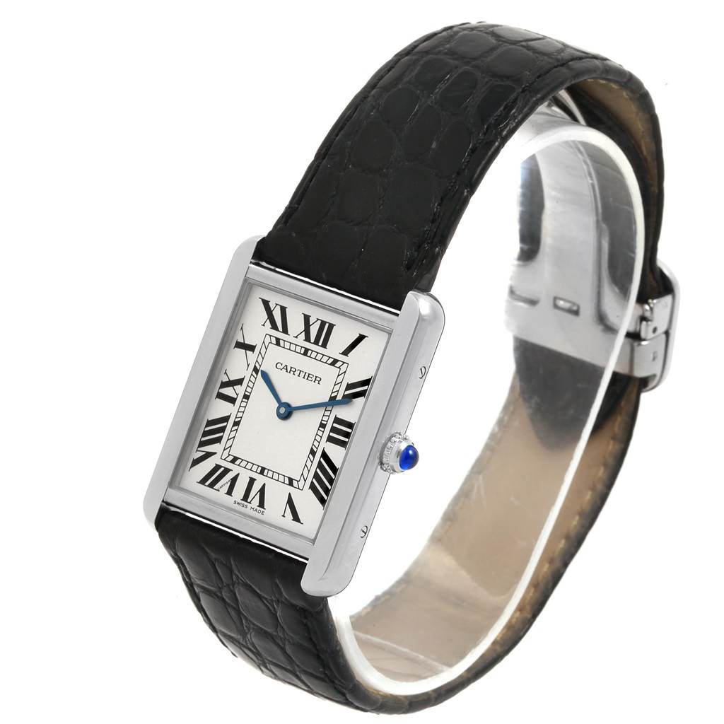 The image shows a Cartier Tank Solo W1018355 Men
s Stainless Steel Silver Dial W1018355 Men
s Stainless Steel Silver Dial watch at a slight angle, highlighting its rectangular face, Roman numerals, and black leather strap.