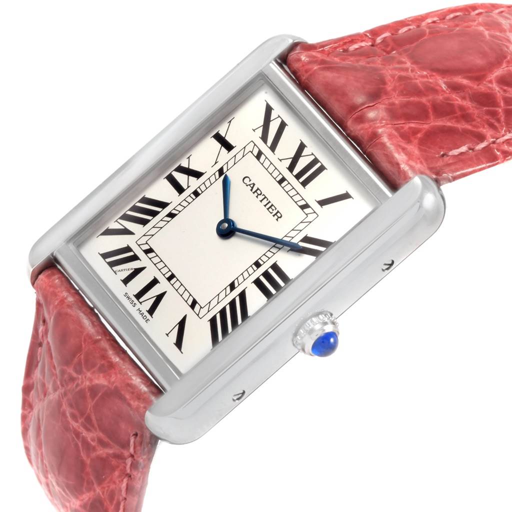 The Cartier Tank Solo W1018355 Men
s Stainless Steel Silver Dial W1018355 Men
s Stainless Steel Silver Dial watch is shown at an angle, highlighting the face, bezel, crown, and red strap.