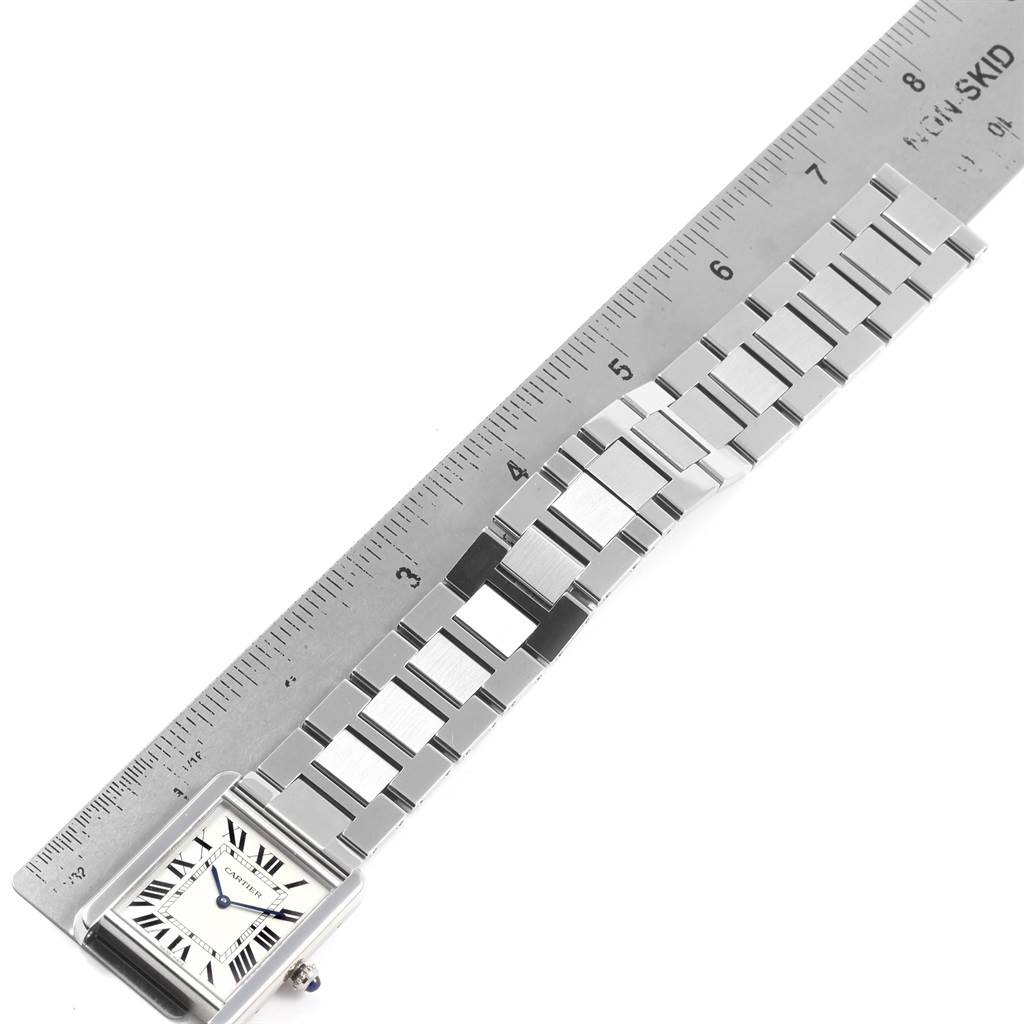 The image shows the Cartier Tank Solo W5200014 Men
s Stainless Steel Silver Dial W5200014 Men
s Stainless Steel Silver Dial watch lying flat with its stainless steel band aligned with a ruler.