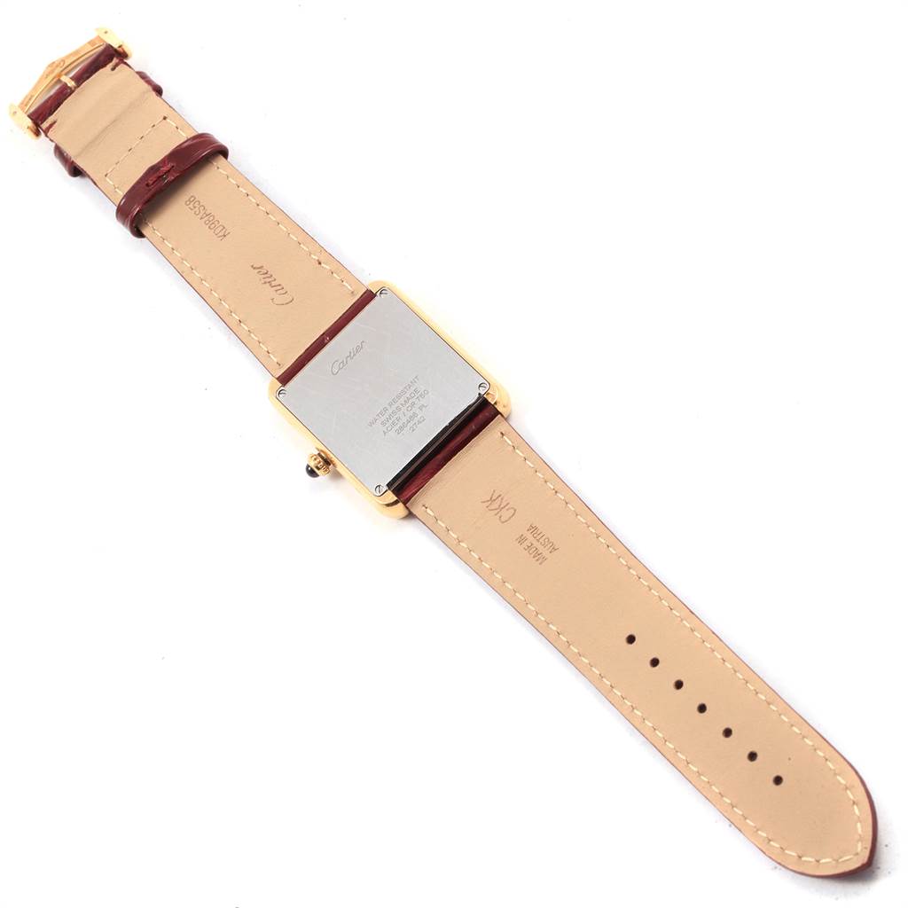 The image shows the back view of a Cartier Tank Solo W1018855 Men
s Steel and Gold (two tone) Silver Dial W1018855 Men
s Steel and Gold (two tone) Silver Dial model watch with its leather strap facing upwards.