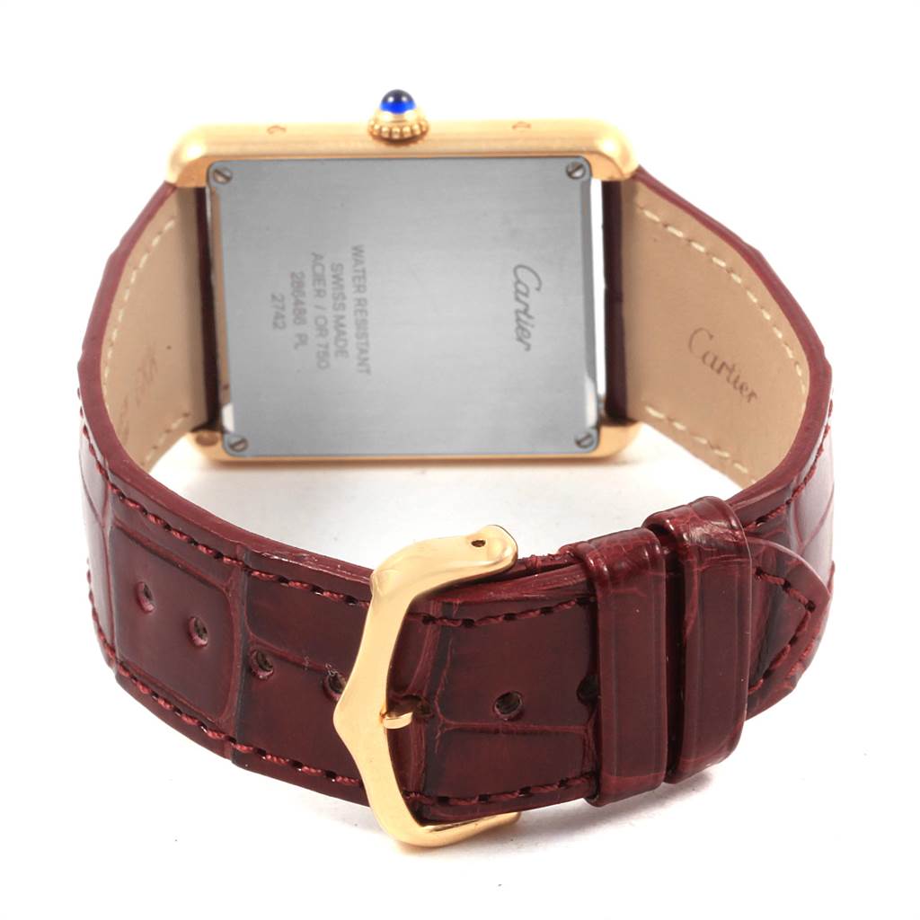 The image shows the back view of a Cartier Tank Solo W1018855 Men
s Steel and Gold (two tone) Silver Dial W1018855 Men
s Steel and Gold (two tone) Silver Dial watch, highlighting the case back, leather strap, and buckle.