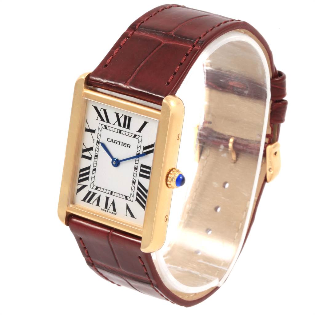 This Cartier Tank Solo W1018855 Men
s Steel and Gold (two tone) Silver Dial W1018855 Men
s Steel and Gold (two tone) Silver Dial watch is shown at an angled view, displaying its rectangular face, gold case, Roman numerals, and leather strap.