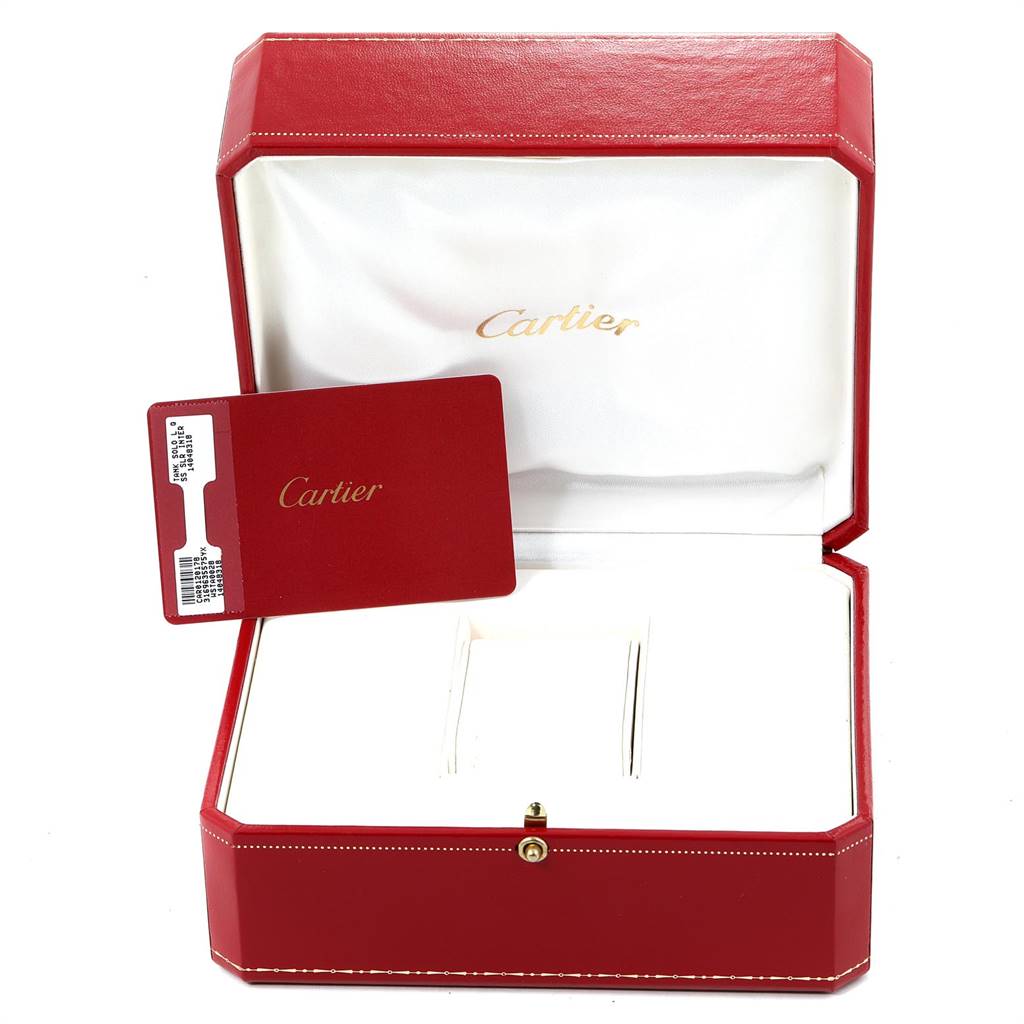 This image shows a red Cartier box with a warranty card for the Tank Solo model, placed inside an open padded case.