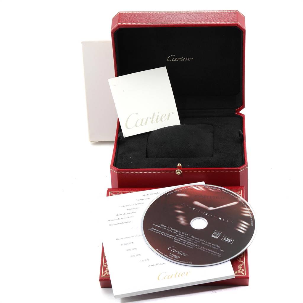 The image shows the packaging and accessories for a Cartier Tank Solo W5200026 Men's Steel and Gold (two tone) Silver Dial W5200026 Men's Steel and Gold (two tone) Silver Dial watch, including a red box, booklet, and CD.