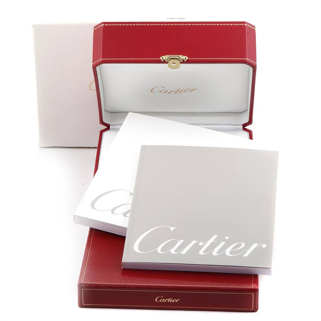 The image shows the packaging and accessories for a Cartier Tank Solo W5200027 Men's Stainless Steel Silver Dial W5200027 Men's Stainless Steel Silver Dial watch, including the red box, white box, and booklets.