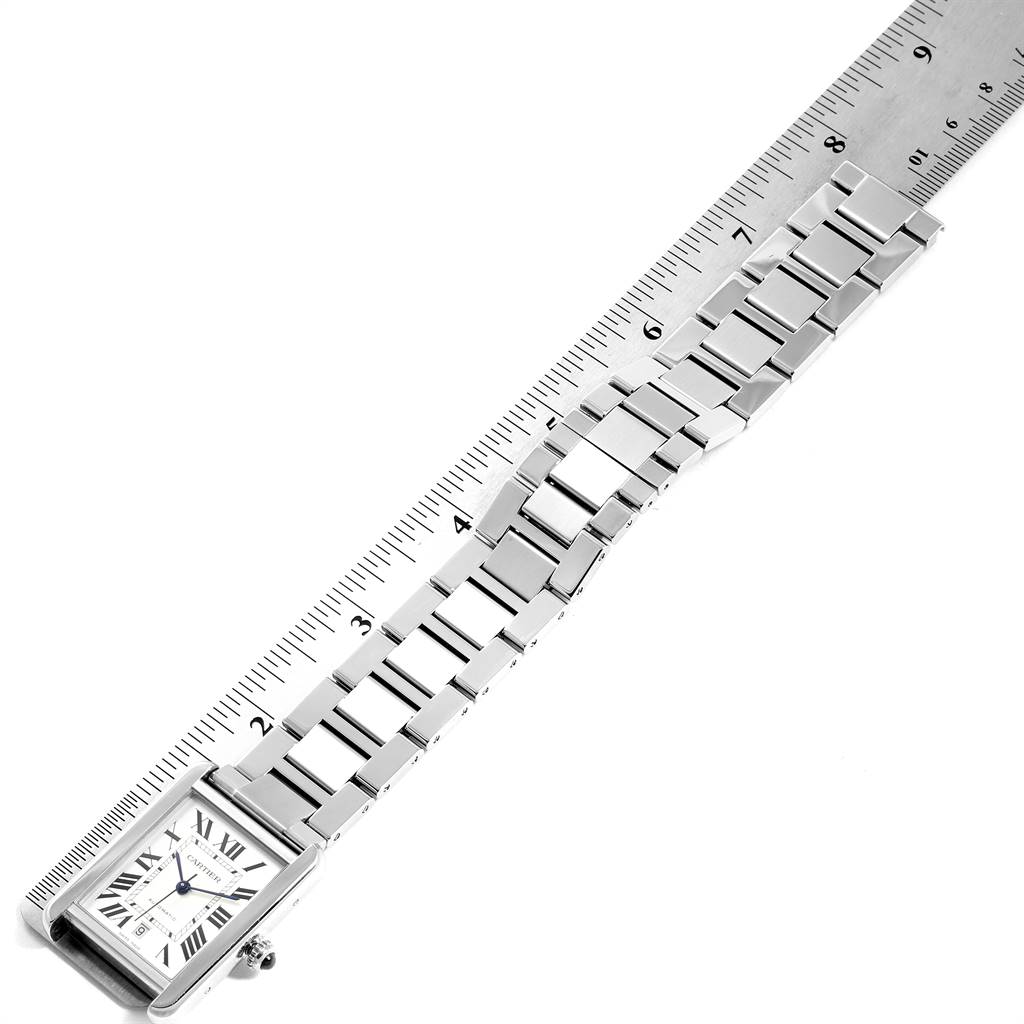 The image shows the Cartier Tank Solo W5200028 Men
s Stainless Steel Silver Dial W5200028 Men
s Stainless Steel Silver Dial watch from a top view, featuring the face and band, with a ruler alongside it.