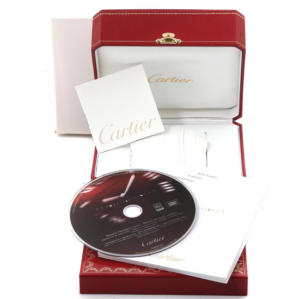 This image shows the packaging and accessories of a Cartier Tank Solo W5200028 Men
s Stainless Steel Silver Dial W5200028 Men
s Stainless Steel Silver Dial watch, including the box, manual, and a DVD.