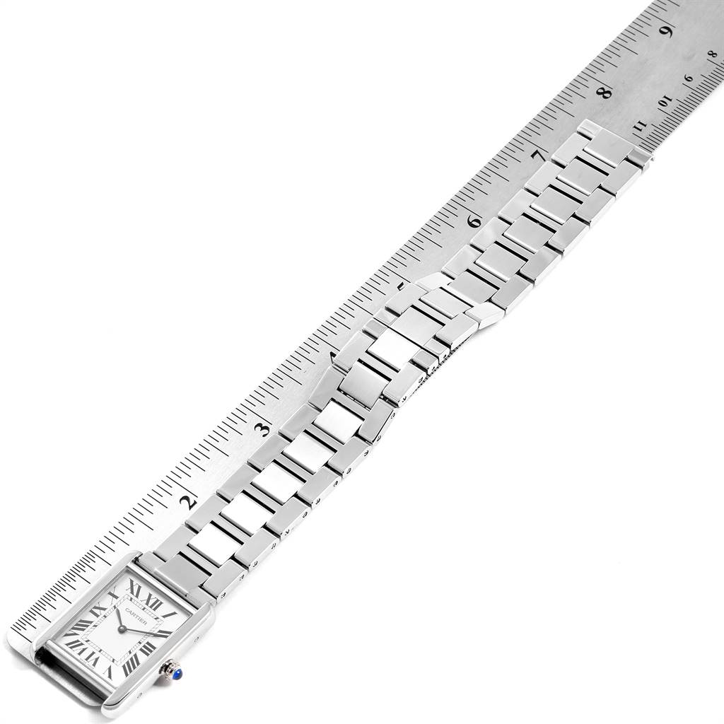 The image shows a Cartier Tank Solo W5200014 Men
s Stainless Steel Silver Dial W5200014 Men
s Stainless Steel Silver Dial watch from a top-down angle, highlighting the watch face, bracelet, and a ruler for scale.