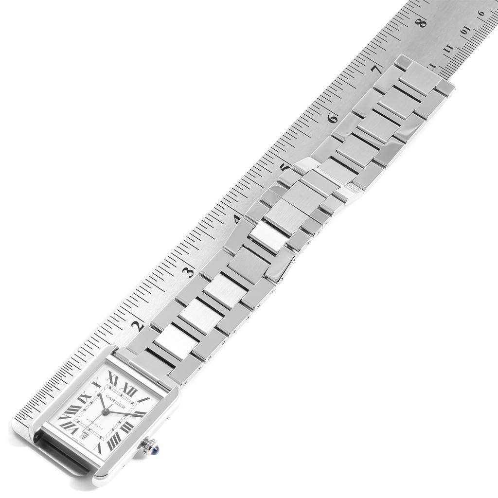 The image shows a top view of a Cartier Tank Solo W5200028 Men's Stainless Steel Silver Dial W5200028 Men's Stainless Steel Silver Dial watch laid alongside a ruler, displaying the watch's face and metal strap.