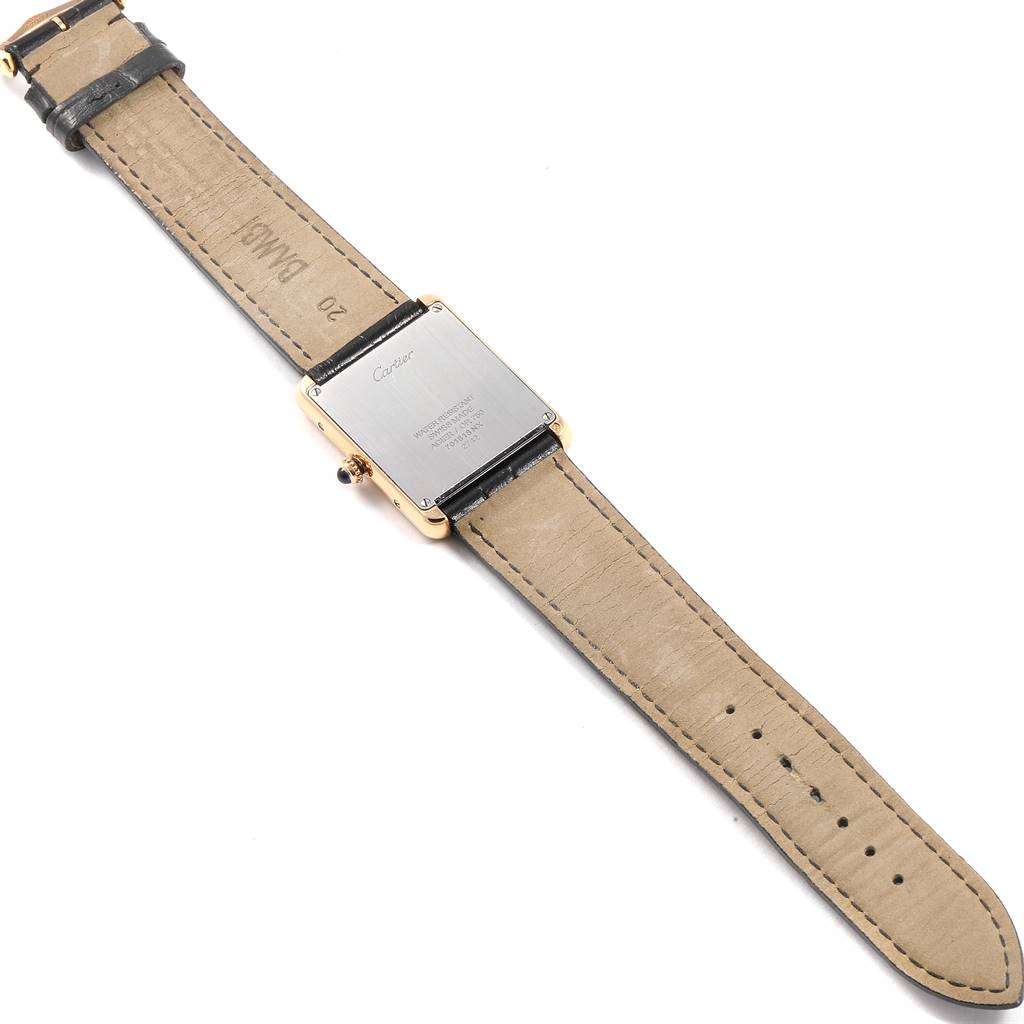 The image shows the back side of a Tank Solo model watch by Cartier, highlighting the case back and leather strap.