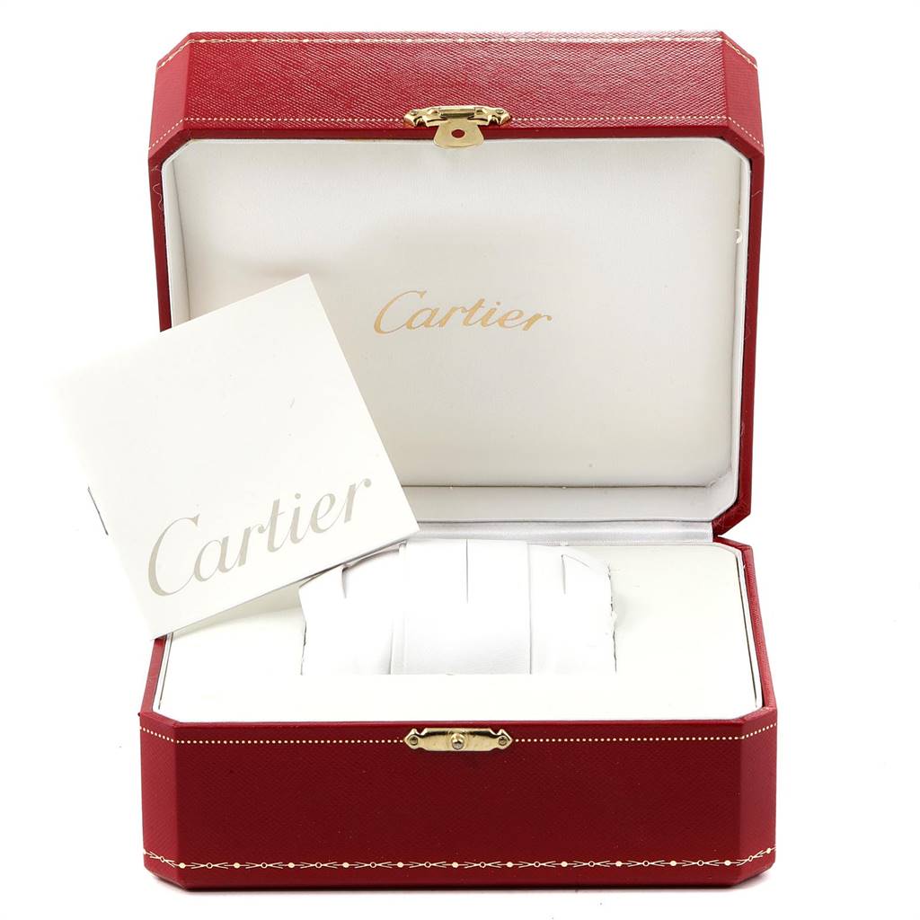 The image shows a Cartier Tank Solo W1018855 Men's Steel and Gold (two tone) Silver Dial W1018855 Men's Steel and Gold (two tone) Silver Dial watch box and booklet placed at an angle revealing the open box's interior.