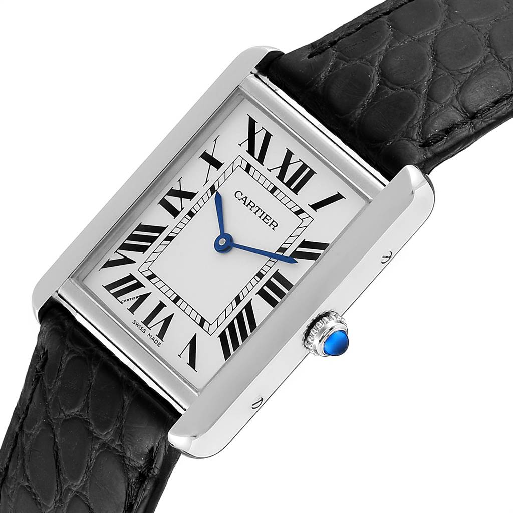 The image shows a Cartier Tank Solo W1018355 Men
s Stainless Steel Silver Dial W1018355 Men
s Stainless Steel Silver Dial watch at an angled close-up view, highlighting the face, Roman numerals, blue hands, and black leather strap.