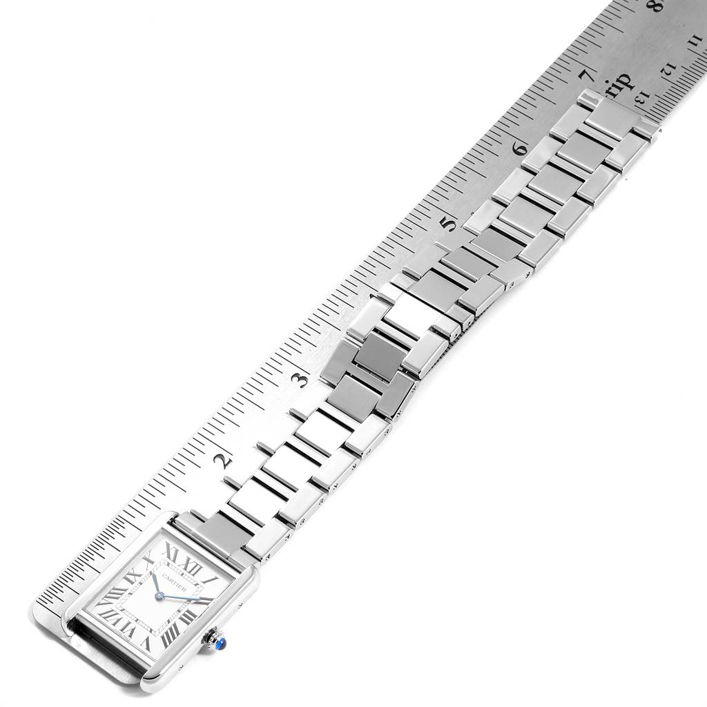 The image shows a top view of the Cartier Tank Solo W5200014 Men
s Stainless Steel Silver Dial W5200014 Men
s Stainless Steel Silver Dial watch, highlighting its dial and metal bracelet, with a ruler for scale.