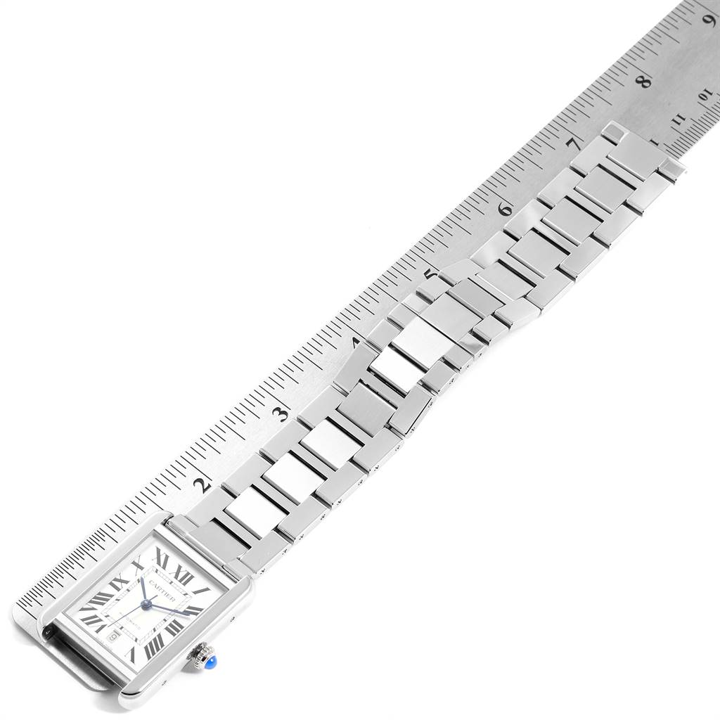 The Cartier Tank Solo W5200028 Men's Stainless Steel Silver Dial W5200028 Men's Stainless Steel Silver Dial watch is shown flat from an overhead angle, alongside a ruler displaying its bracelet.