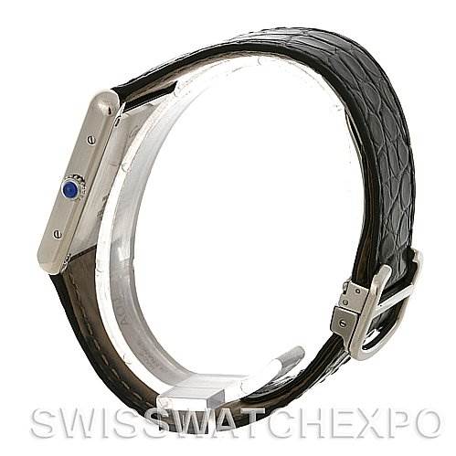 The image shows a Cartier Tank Solo W1018355 Men's Stainless Steel Silver Dial W1018355 Men's Stainless Steel Silver Dial watch from a side angle, highlighting its case, crown with a blue cabochon, and black leather strap.