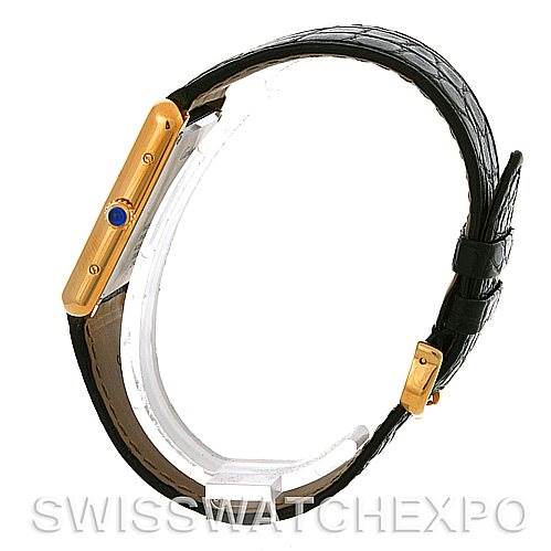 The image shows a side view of a Cartier Tank Solo W1018855 Men
s Steel and Gold (two tone) Silver Dial W1018855 Men
s Steel and Gold (two tone) Silver Dial watch with its gold-tone case and black leather strap.