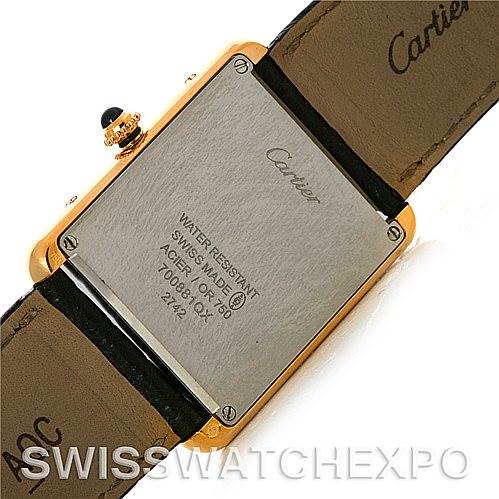 The image shows the back case and part of the leather strap of a Cartier Tank Solo W1018855 Men
s Steel and Gold (two tone) Silver Dial W1018855 Men
s Steel and Gold (two tone) Silver Dial watch.