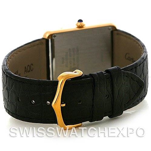 The image shows the back view of a Cartier Tank Solo W1018855 Men
s Steel and Gold (two tone) Silver Dial W1018855 Men
s Steel and Gold (two tone) Silver Dial watch, highlighting its black leather strap and gold buckle.