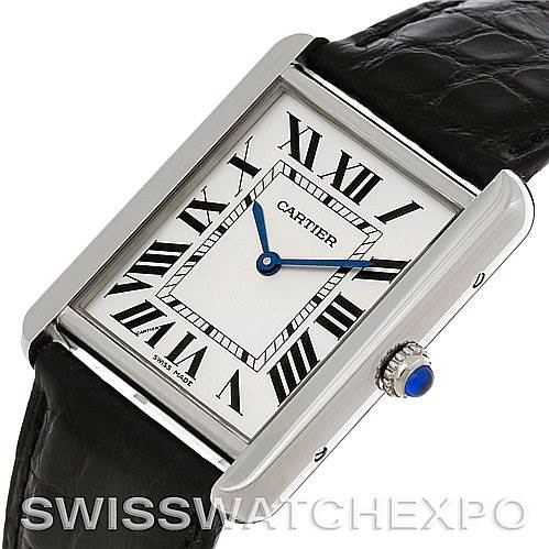 This Cartier Tank Solo W1018355 Men's Stainless Steel Silver Dial W1018355 Men's Stainless Steel Silver Dial watch is shown from an angled top view, highlighting the face, Roman numerals, blue hands, and crown with a blue cabochon.