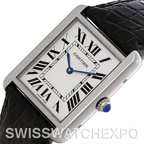 This image shows a Cartier Tank Solo W1018355 Men's Stainless Steel Silver Dial W1018355 Men's Stainless Steel Silver Dial watch at an angle emphasizing the rectangular face, Roman numerals, and crown with a blue stone.