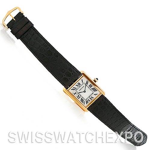 This image shows a Cartier watch with a rectangular face and a black leather strap, taken from a top-down angle.