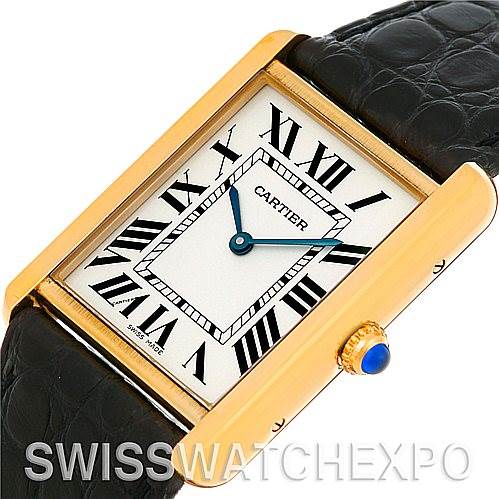 The image shows a Cartier watch with a rectangular face, gold casing, black leather strap, and Roman numerals.