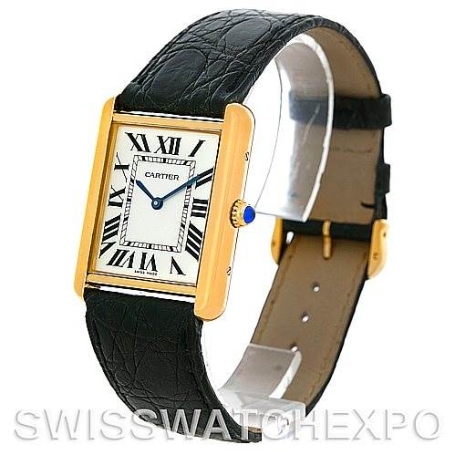 This Cartier Tank Solo W1018855 Men
s Steel and Gold (two tone) Silver Dial W1018855 Men
s Steel and Gold (two tone) Silver Dial watch is shown at an angled view, highlighting its rectangular gold case, roman numeral dial, and black leather strap.