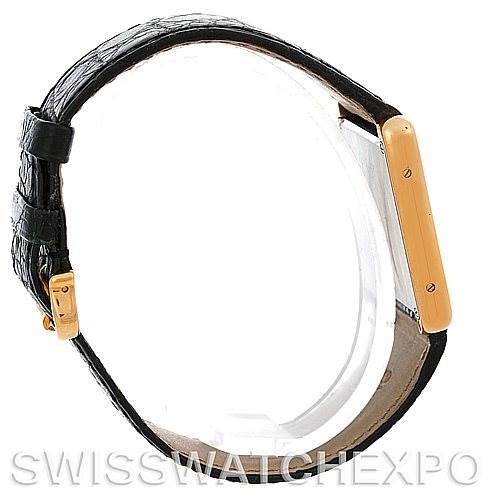 The image shows a side view of the Cartier Tank Solo W1018855 Men
s Steel and Gold (two tone) Silver Dial W1018855 Men
s Steel and Gold (two tone) Silver Dial watch, highlighting its gold case and black leather strap.