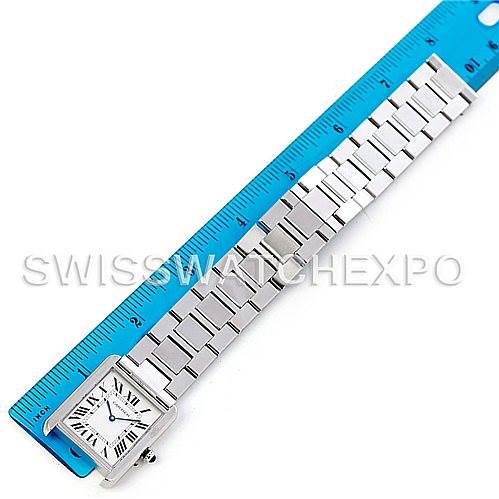 The image shows a Cartier Tank Solo W5200014 Men
s Stainless Steel Silver Dial W5200014 Men
s Stainless Steel Silver Dial watch laid flat next to a blue ruler, showcasing its full face and metal bracelet.