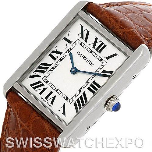 This image shows a close-up angled view of the Cartier Tank Solo W1018355 Men
s Stainless Steel Silver Dial W1018355 Men
s Stainless Steel Silver Dial watch face and a portion of its brown leather strap.