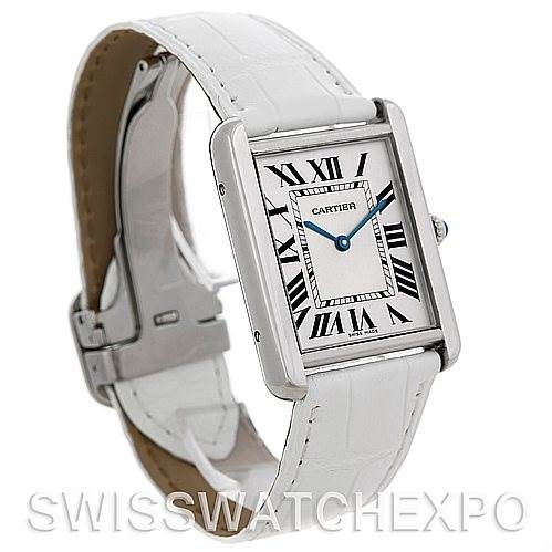 This image shows a side angle of the Cartier Tank Solo W1018355 Stainless Steel Silver Dial W1018355 Stainless Steel Silver Dial watch with a white strap and its clasp partially visible.