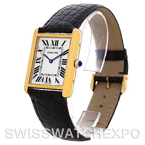The image shows a Cartier Tank Solo W1018855 Men
s Steel and Gold (two tone) Silver Dial W1018855 Men
s Steel and Gold (two tone) Silver Dial watch with a gold case, leather strap, and blue cabochon crown, viewed from a three-quarter angle.