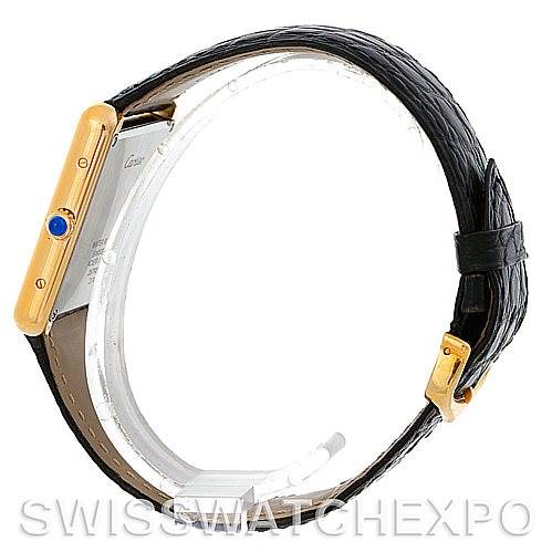 This image shows a side profile of the Cartier Tank Solo W1018855 Men
s Steel and Gold (two tone) Silver Dial W1018855 Men
s Steel and Gold (two tone) Silver Dial watch, highlighting its gold case, crown with blue cabochon, and black leather strap.