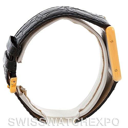 The image shows a Cartier Tank Solo W1018855 Men's Steel and Gold (two tone) Silver Dial W1018855 Men's Steel and Gold (two tone) Silver Dial watch viewed from the side, highlighting the watch's gold case and leather strap.