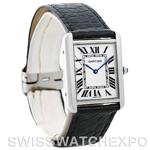 The image shows a Cartier Tank Solo W1018355 Men
s Stainless Steel Silver Dial W1018355 Men
s Stainless Steel Silver Dial watch at a three-quarter angle, displaying the face, Roman numeral dial, blue hands, and black leather strap.
