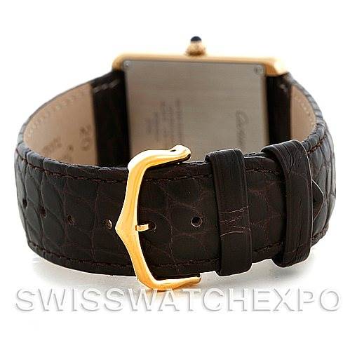 The image shows the back of a Cartier Tank Solo W1018855 Men
s Steel and Gold (two tone) Silver Dial W1018855 Men
s Steel and Gold (two tone) Silver Dial watch, focusing on the black leather strap and gold buckle clasp.