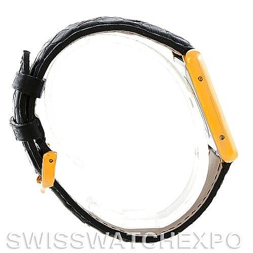 The image shows a side view of a Cartier Tank Solo W1018855 Men
s Steel and Gold (two tone) Silver Dial W1018855 Men
s Steel and Gold (two tone) Silver Dial watch, focusing on the gold-colored case and black leather strap.