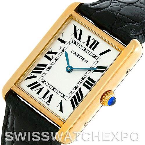 The image shows the face and side view of the Tank Solo model by Cartier, highlighting its Roman numerals and crown with a blue cabochon.