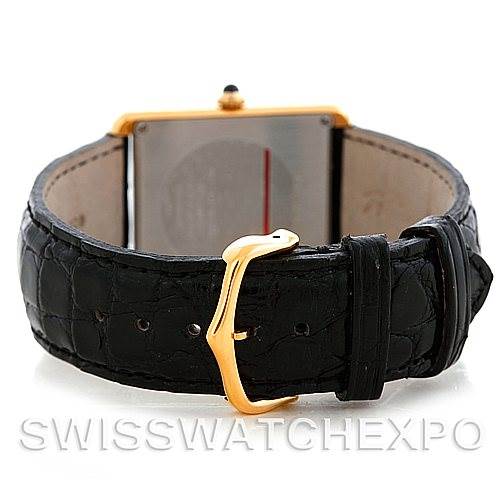 The image shows the back view of a Cartier Tank Solo W1018855 Men
s Steel and Gold (two tone) Silver Dial W1018855 Men
s Steel and Gold (two tone) Silver Dial watch, focusing on the leather strap and clasp.